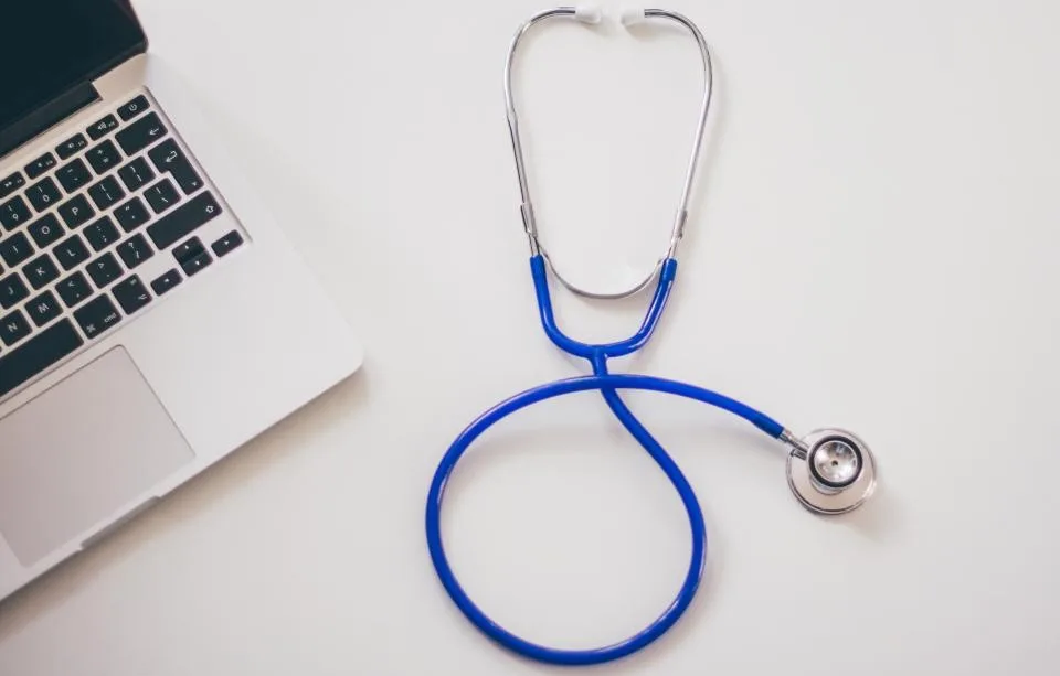 Stethoscope beside a laptop for a medical practice website