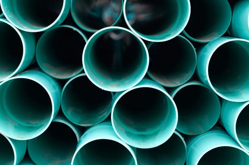 Stack of new plumbing pipes ready for a job