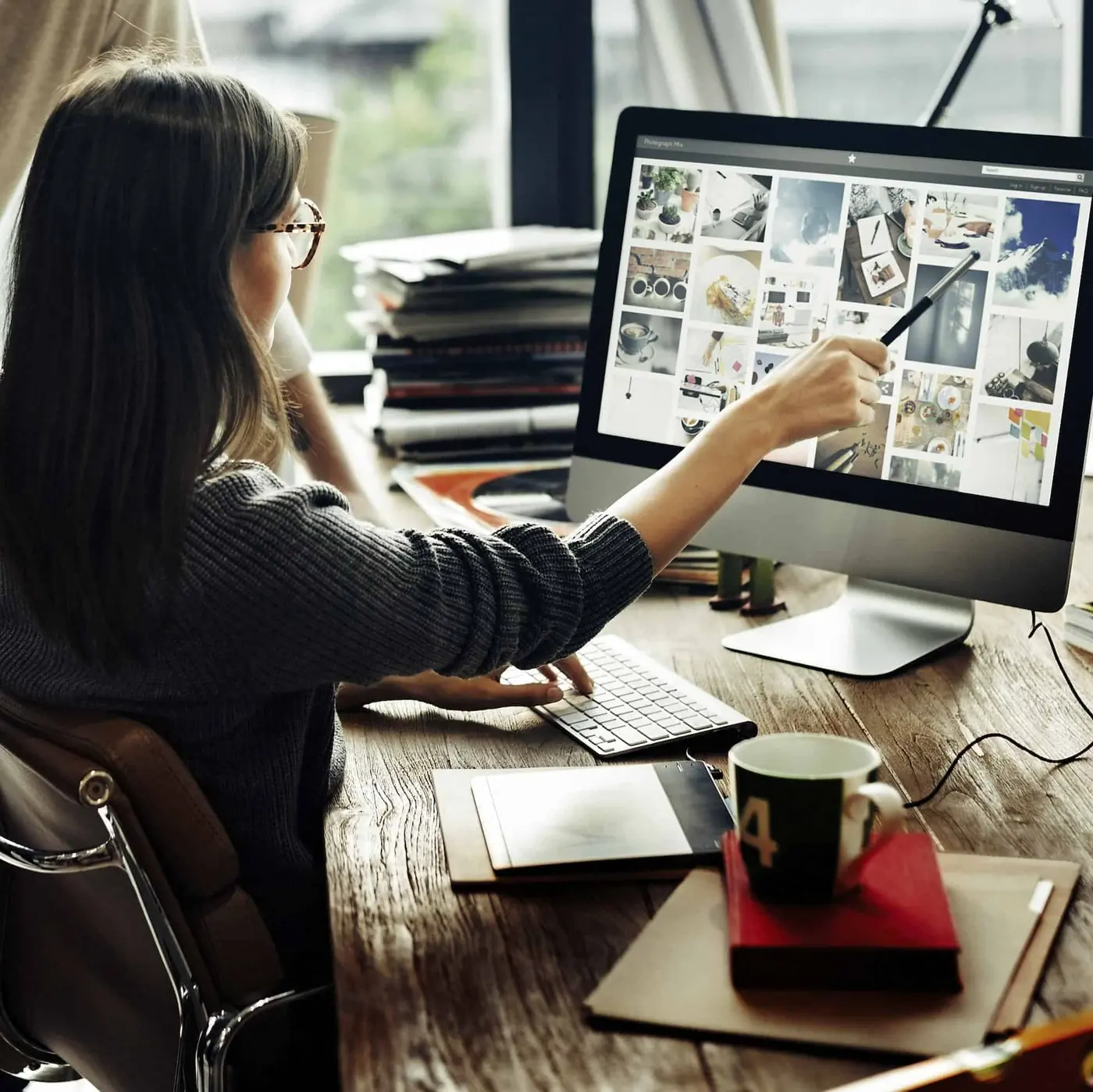 Agent brainstorming branding ideas at a desk with design sketches