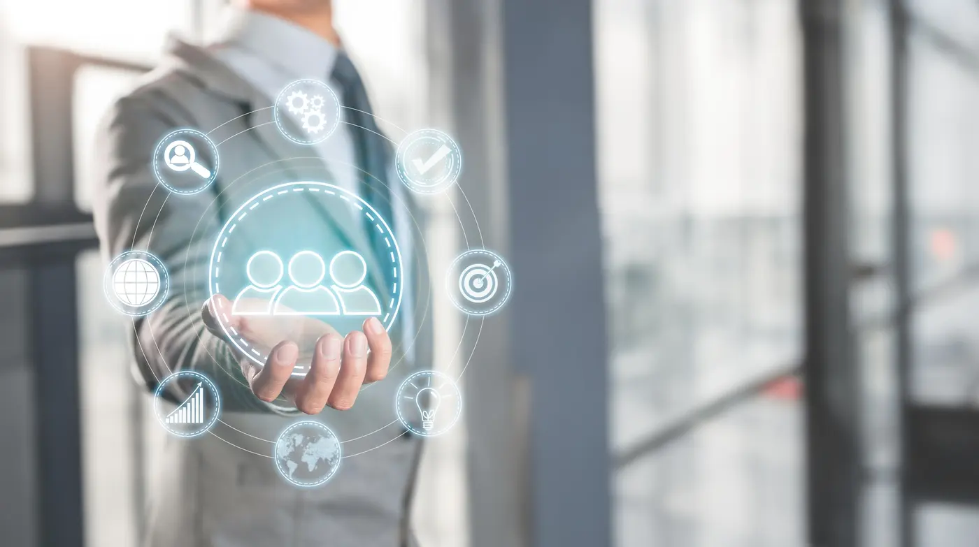 Business professional holding a ring of connected technology icons