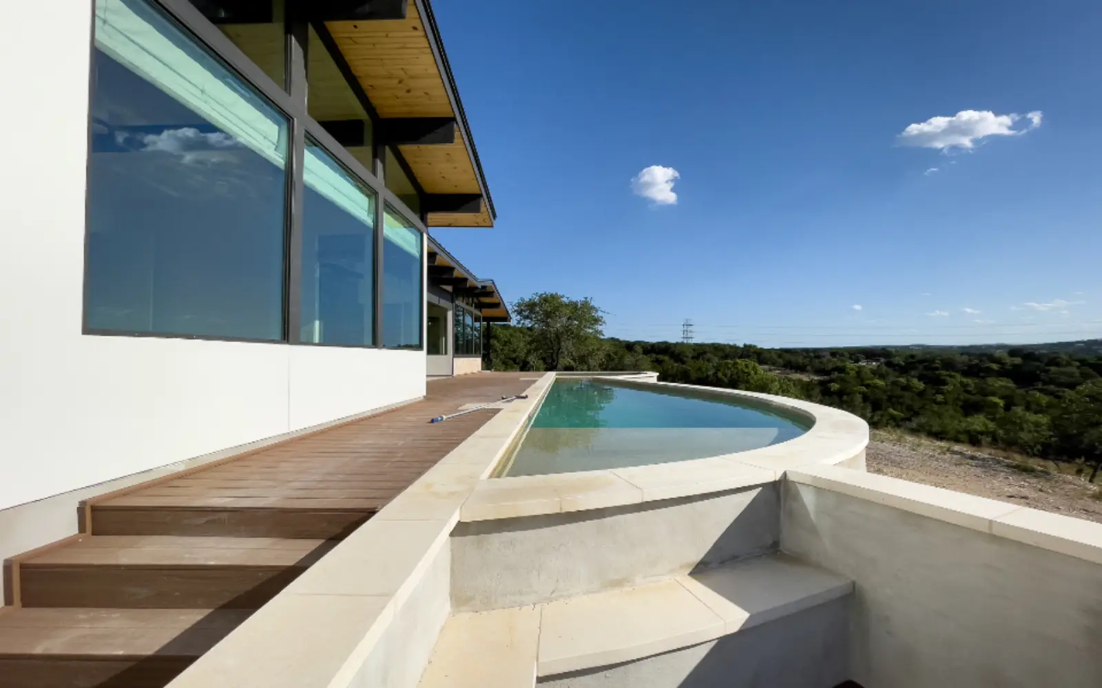 Modern home with a pool overlooking a green valley