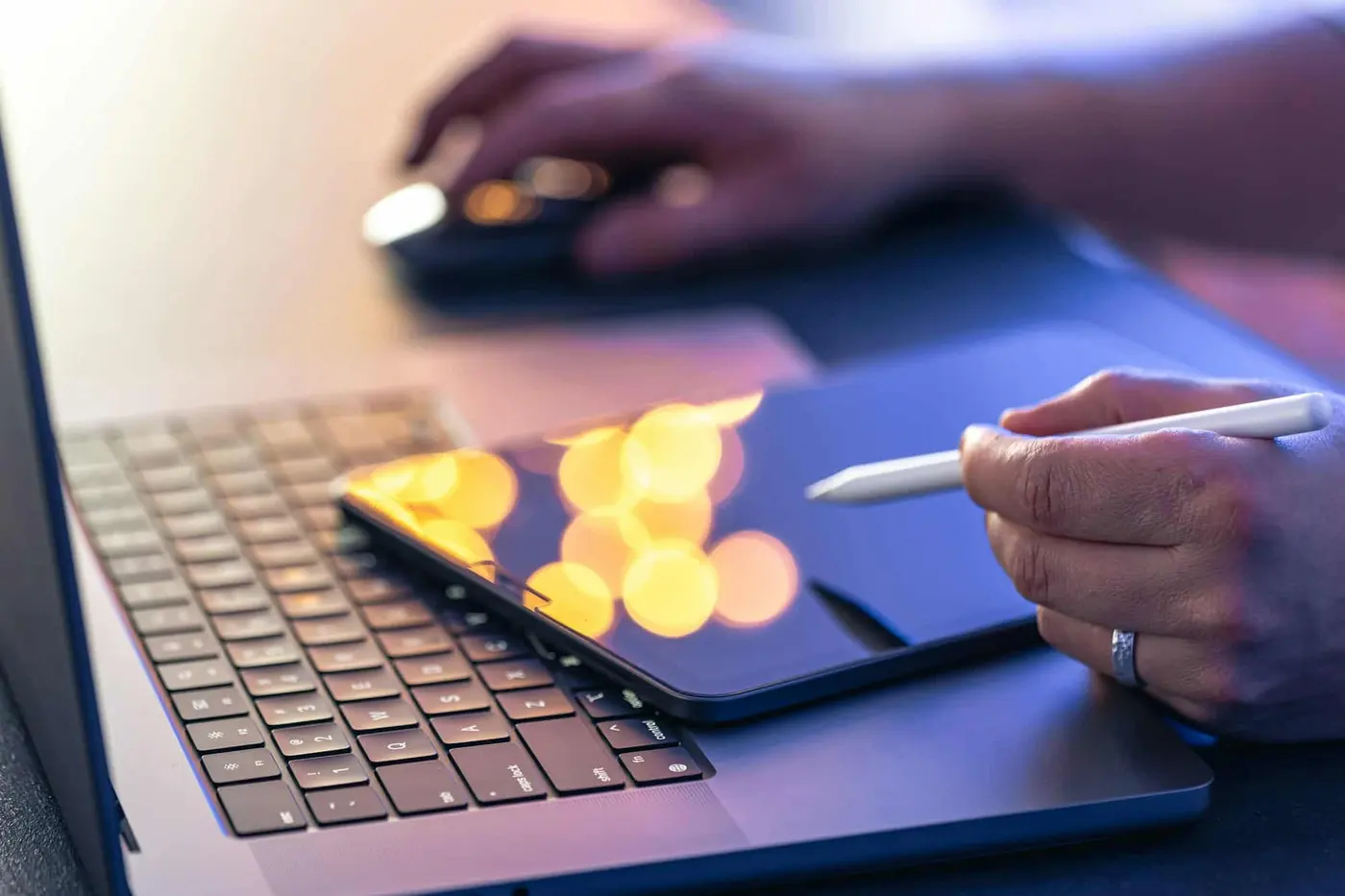 Business owner reviewing results on a tablet and laptop